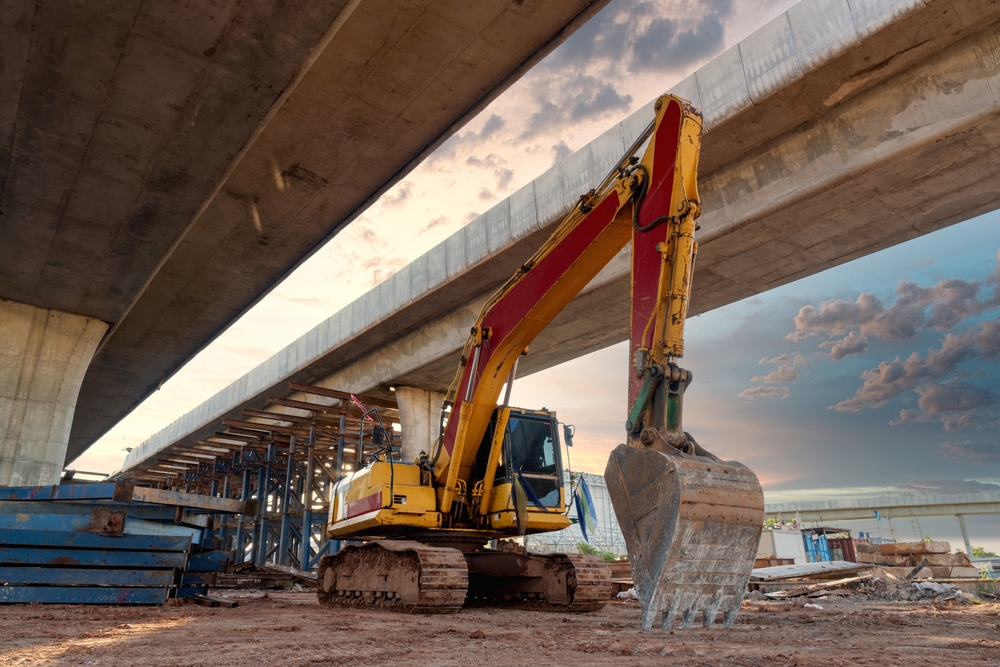 An excavator begins digging at a construction site